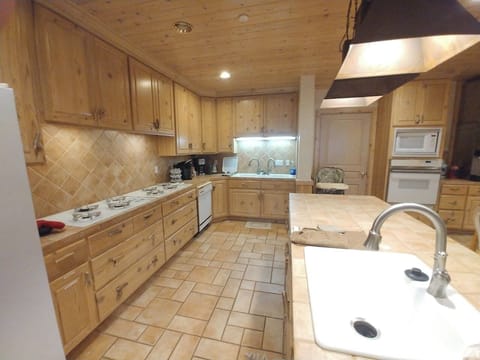 Chef's kitchen with 8 bruner gas range stoves, ovens, microwave, 3 sinks, garbage disposal, toaster, instapot and more.