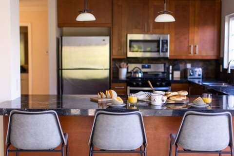 Kitchen features a breakfast bar.