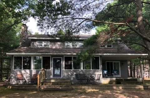Front of cottage with large deck and covered side deck