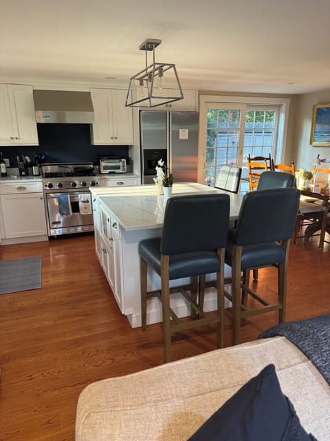 Updated quartz counters in kitchen with seating at counter