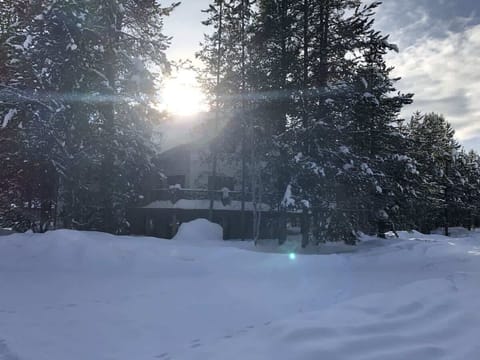 Welcome to Winchester Lodge with a beautiful view of the cabin from the road in the winter.