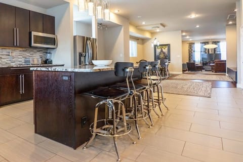 Large tile flooring extends across the kitchen. - Upper Townhouse