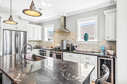 Fully stocked kitchen with stainless appliances, double ovens, microwave