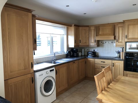 Kitchen has washing machine and dishwasher