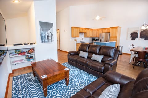 Airy, bright and spacious living room with 70' flat screen TV
