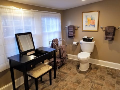Spacious bathroom with makeup vanity.