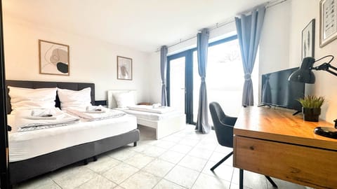 Bedroom Five with double bed, single bed and work table