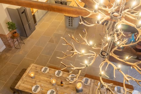 The Owl House: Dominated by a magnificent open plan living space and huge, handmade table with impressive chandelier made with shed antlers