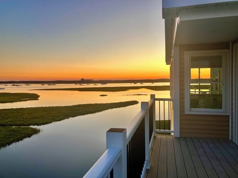 View of the marsh and sunset from the upper deck with seating