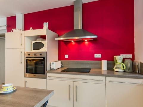 Cabinetry, Property, Countertop, Wood, Kitchen, Building, Kitchen Stove, Orange, Lighting, Interior Design