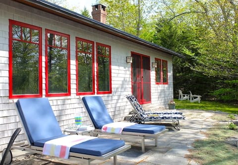 Lounge chairs on the bluestone terrace catch the sun.