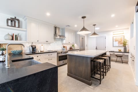 View towards kitchen island with 3 bar stools