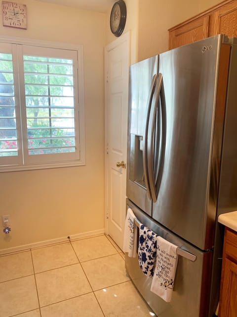 High end cafe fridge in kitchen, plus additional fridge in garage for use.