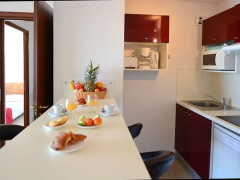 Furniture, Table, Property, Cabinetry, Food, Tableware, Dishware, Plant, Building, Chair