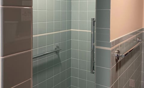 New downstairs bathroom incudes a walk-in shower and washer/dryer.