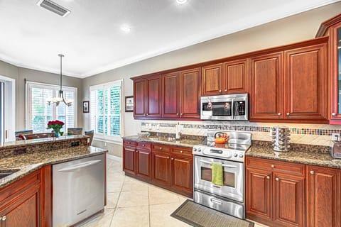 Large kitchen with granite counters and stainless steel appliances.  Everything you need to cook at home.