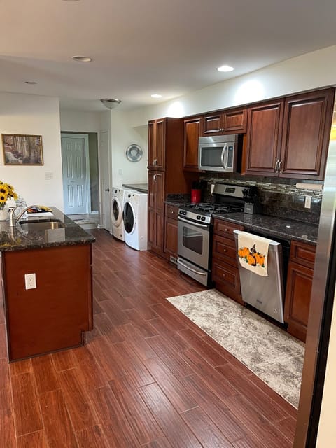 Kitchen with granite counters, island with another sink.