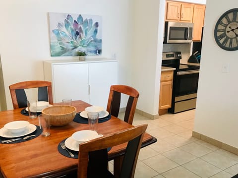The dining area has additional storage, and the table seats 4, plus 3 bar stools.