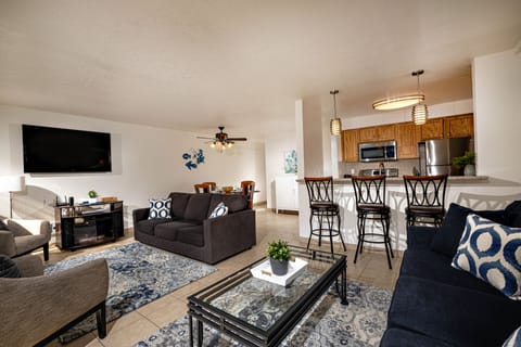 The dining table seats 4, plus 3 barstools.