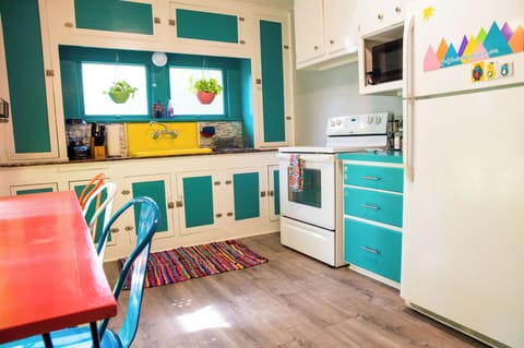 Bright cheerful kitchen with coffee maker, cookware, & all you need to feel home