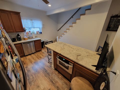 Microwave under the kitchen island & soap for the dishwasher in adjacent cabinet