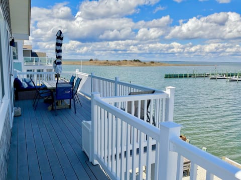 Your bayfront deck with dining table and comfortable daybed for relaxing.
