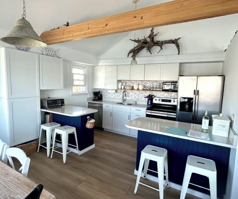 Quartz countertops, stainless appliances, marble backsplash, island seating 