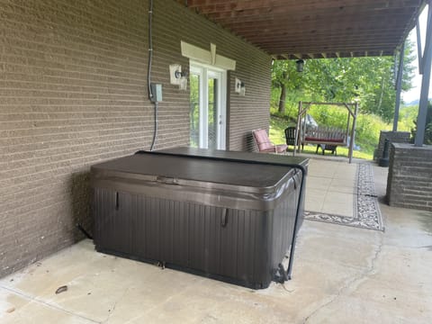 View of hottub on lower level, just off Master suite. Sitting area and firepit
