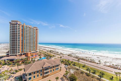 Stunning beachfront resort towers rise against crystal-clear Gulf waters and pristine white sand beaches.
