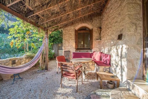 Backyard with table and seating and a hammock for ultimate relaxing times