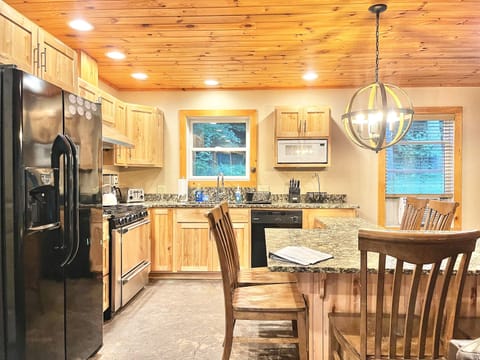 Beautiful kitchen with granite table top has seating for 8.