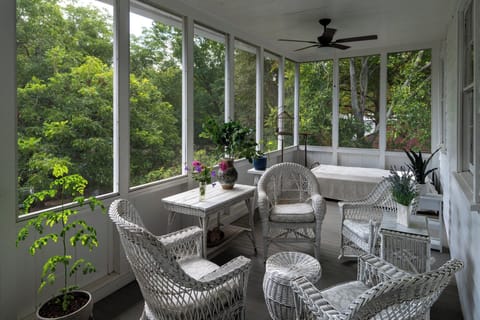 Screened second story porch overlooking gardens