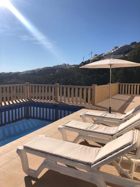 Terrace overlooking pool and mountainside with ample room for eight sunbeds