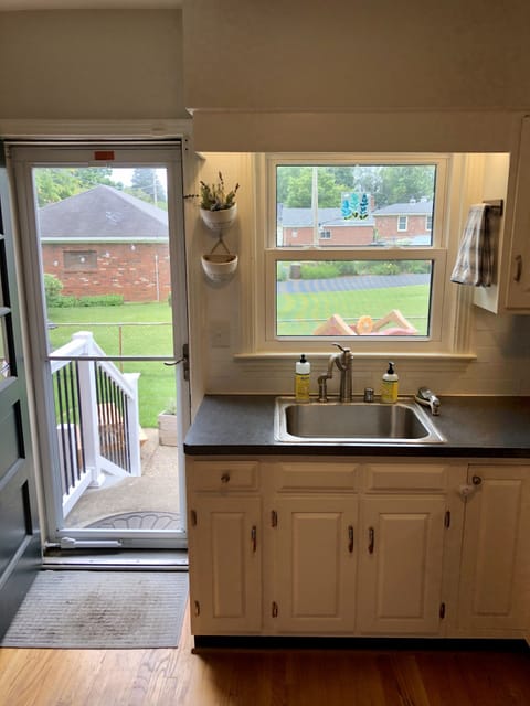 Kitchen, back door leads to patio: outdoor movie screen, corn hole set, fire pit