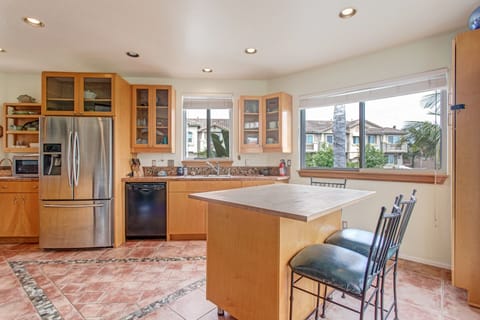 Breakfast for two? The kitchen offers a lot of natural light from the surrounding windows.