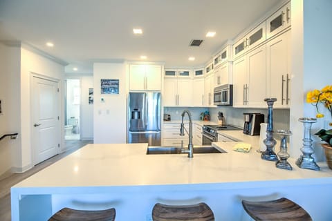1st Flr Kitchen open to living room, view of pool and water