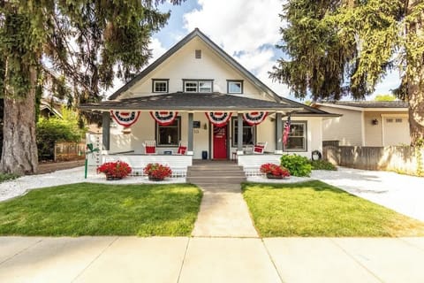 Front of home with rocking chairs and porch swing