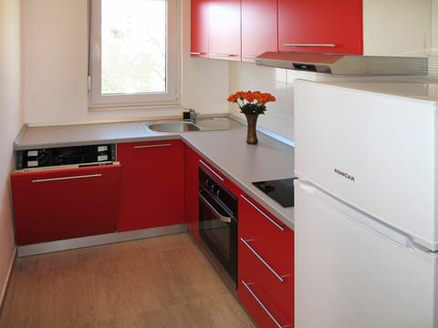 Countertop, Cabinetry, Kitchen, Room, Furniture, Property, Red, Major Appliance, Floor, Interior Design