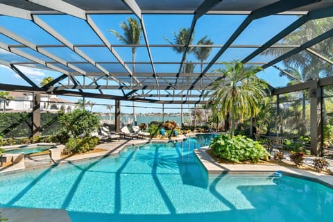 Behold the unparalleled beauty of Conover Court Villa’s resort-like pool and bay views during the day...