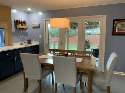 Kitchen Table with bar area behind.  Door to patio area