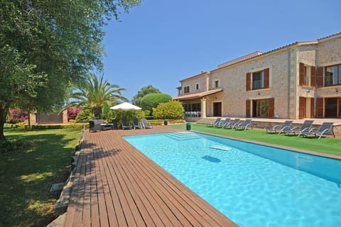 Santa Maria, a luxurious country house in Mallorca with a large pool and ping pong table, ideal for relaxing and enjoying a natural setting.