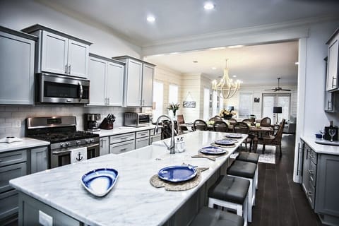 Kitchen bar with farm sink and 4 stools.