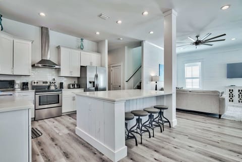 Open kitchen w/ generous counter space & seating for casual bites.