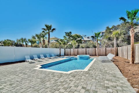 Sun-soaked courtyard pool framed by palms, perfect for cooling off after a day out.
