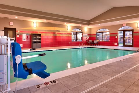Indoor pool with surrounding seating and safety features.