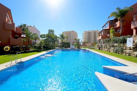 Stunning communal swimming pool surrounded by well maintained gardens