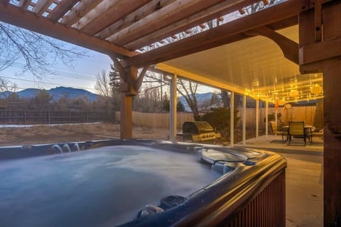 Soak under the pergola – private hot tub with mountain views at sunset.