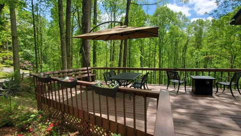 Private creekside deck with outdoor dining, fire table, and peaceful mountain surroundings