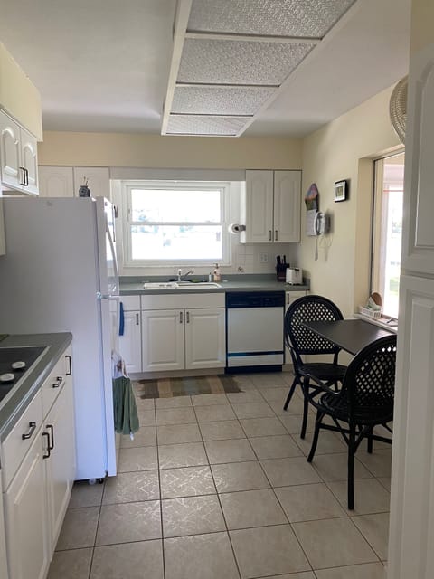 This stocked kitchen has lakeviews from 2 windows & access to screenpatio.