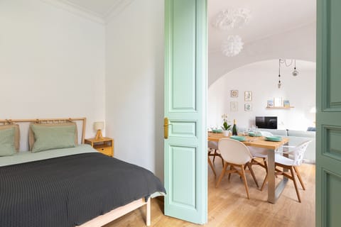 One of the three bedrooms of the Modernist Family Barcelona Apartment holiday apartment, with kitchen and living room.
